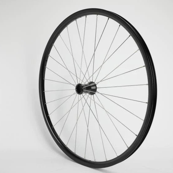 Close-up of a manual wheelchair showing the large rear wheel with handrim and spokes, and the smaller front caster with fork. Alt: Rear wheel and caster on a manual wheelchair.