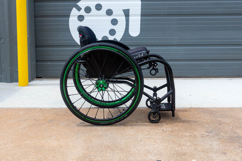 Side view of a Push Lox Wheelchair Wheel Lock system mounted to a Reckless Wheelchairs Ultra Rigid Wheelchair