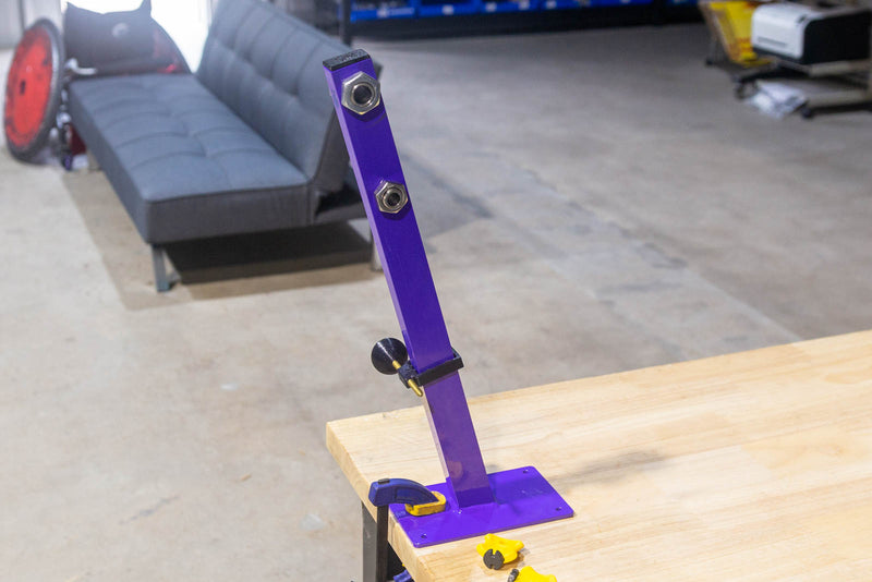 Wheelchair wheel truing stand with two axle receivers