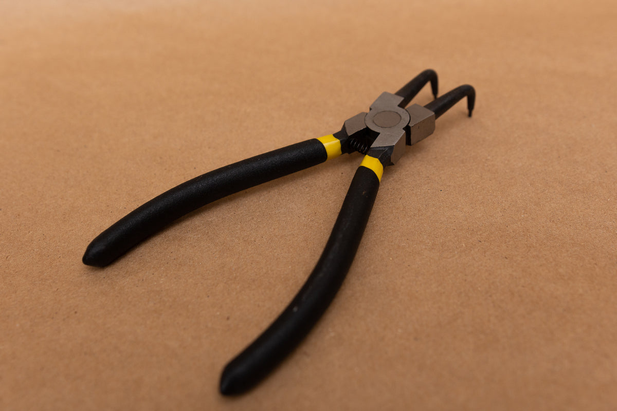 Right-angle snap ring pliers for wheelchair caster forks