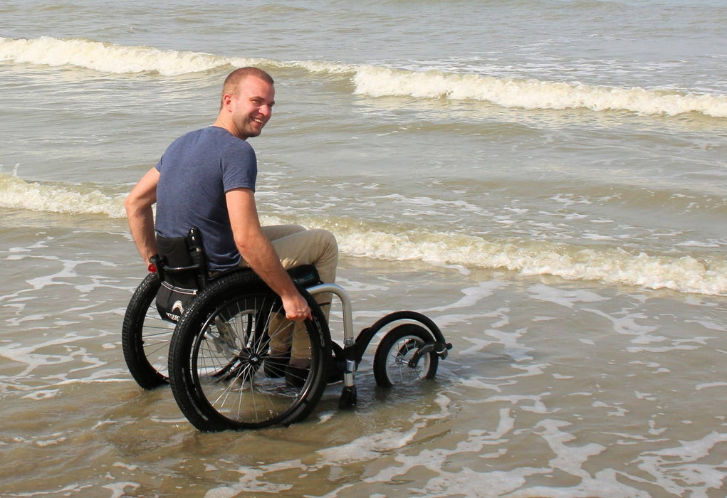 Freewheel Wheelchair Attachment user in water at beach