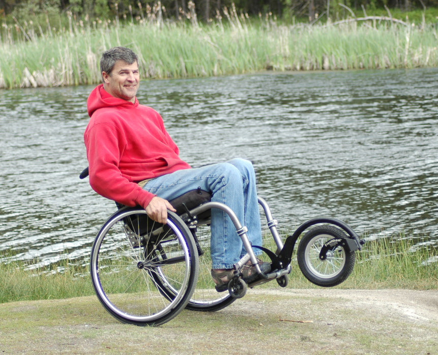 Freewheel Wheelchair Attachment user doing a wheelie